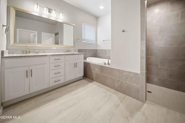 bathroom featuring vanity, shower with separate bathtub, and hardwood / wood-style floors