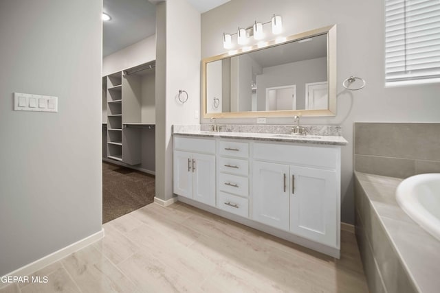 bathroom with vanity and a bathing tub