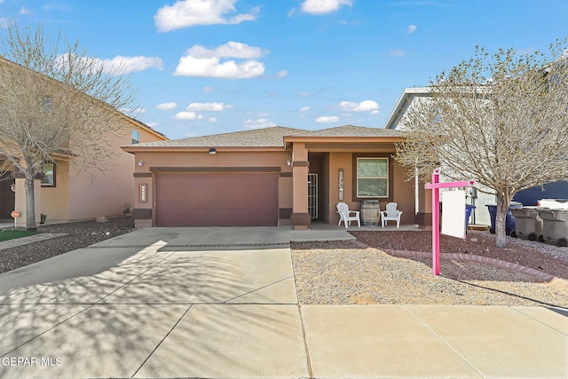 view of front of property featuring an attached garage, roof with shingles, concrete driveway, and stucco siding