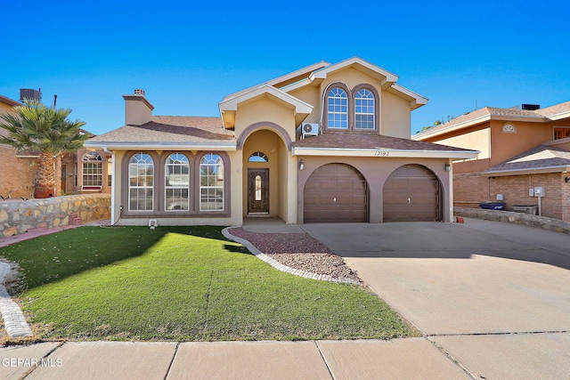 mediterranean / spanish-style house featuring a garage and a front yard