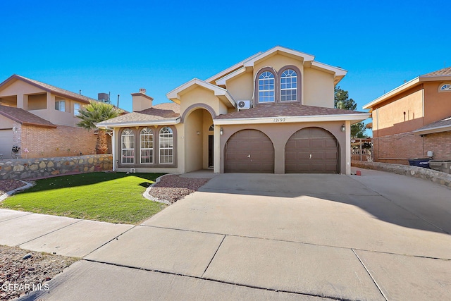 mediterranean / spanish home with a garage and a front lawn