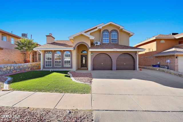 mediterranean / spanish-style house with a garage and a front yard