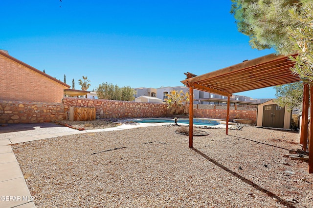 view of yard featuring a fenced in pool, a pergola, and a storage shed