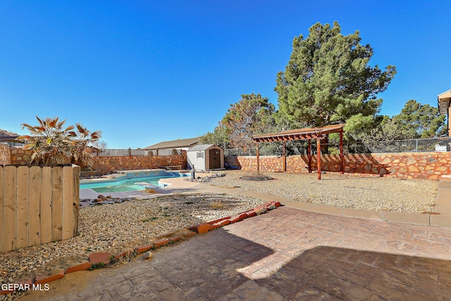 view of pool with a patio area and a shed