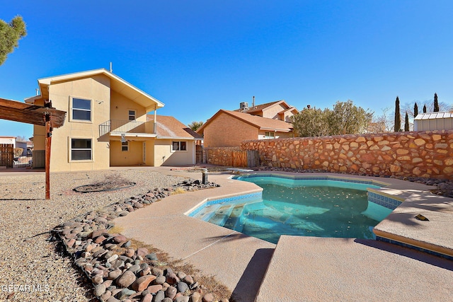 view of swimming pool with a diving board