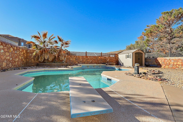 view of pool featuring a diving board and a storage unit