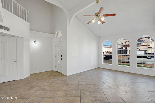 unfurnished room with beamed ceiling, high vaulted ceiling, and ceiling fan