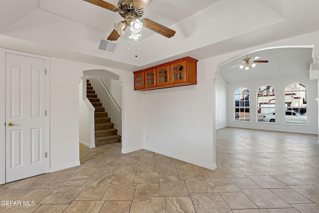 spare room featuring light tile patterned floors, a raised ceiling, and ceiling fan