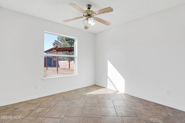 tiled spare room with a textured ceiling and ceiling fan