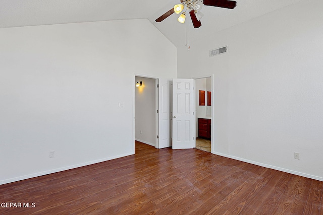 empty room with ceiling fan, high vaulted ceiling, and dark hardwood / wood-style flooring