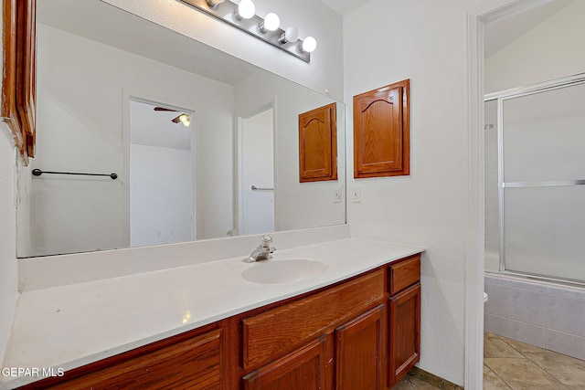 bathroom with vanity, bath / shower combo with glass door, and tile patterned flooring