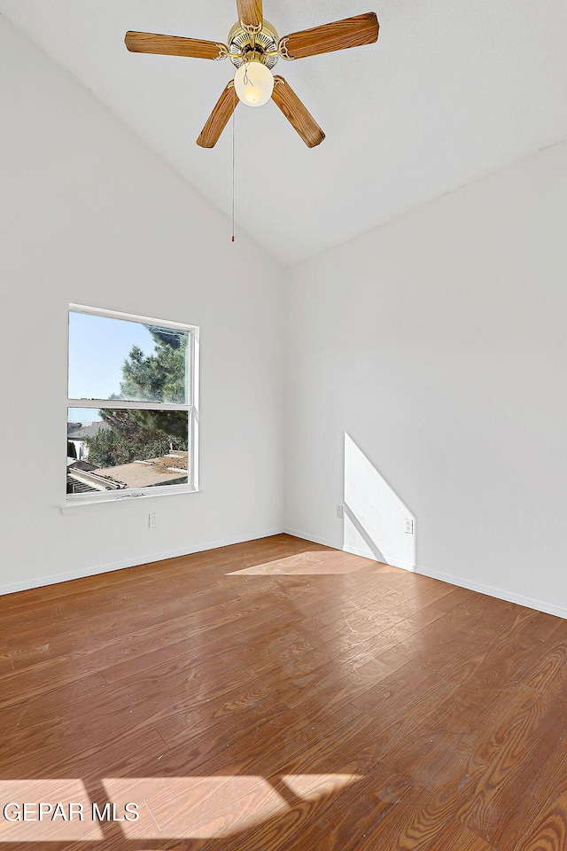 empty room with ceiling fan, wood-type flooring, and vaulted ceiling