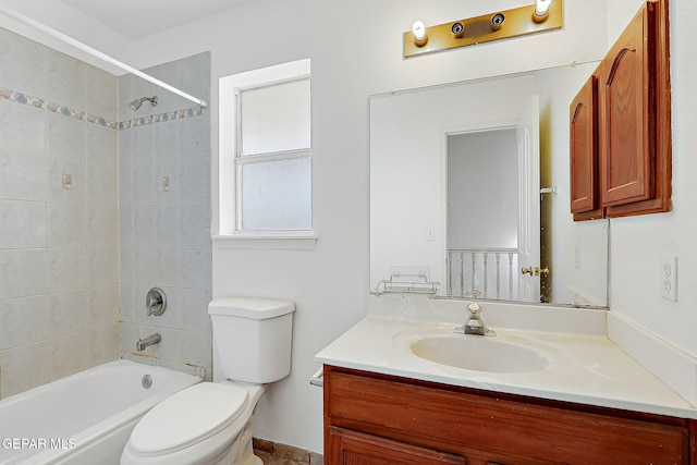 full bathroom with vanity, tiled shower / bath combo, and toilet