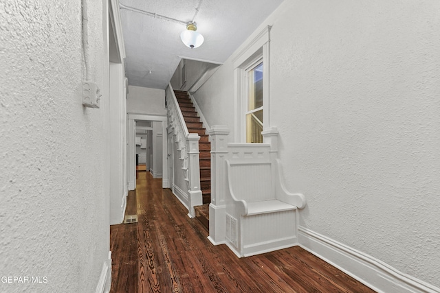 corridor featuring dark hardwood / wood-style floors