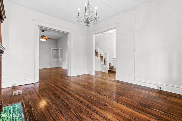 unfurnished dining area featuring dark hardwood / wood-style floors and ceiling fan with notable chandelier