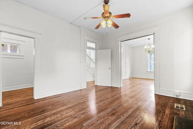 unfurnished room featuring hardwood / wood-style floors and ceiling fan with notable chandelier