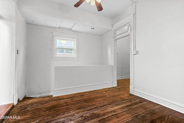 empty room featuring dark wood-type flooring and ceiling fan