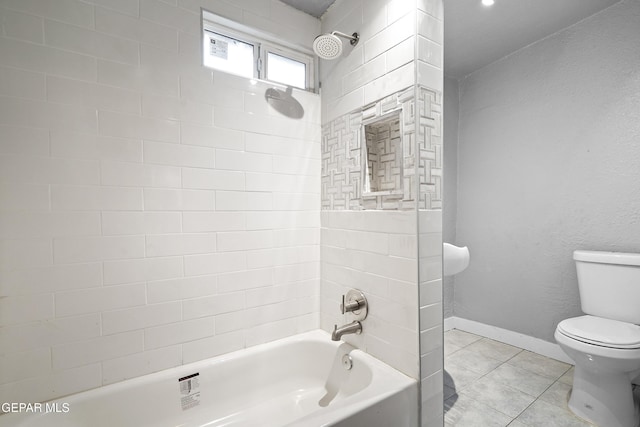 bathroom featuring tile patterned floors, toilet, and tiled shower / bath combo