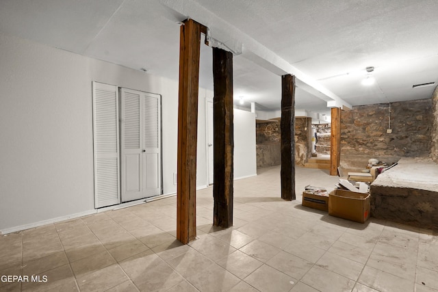 basement with a textured ceiling