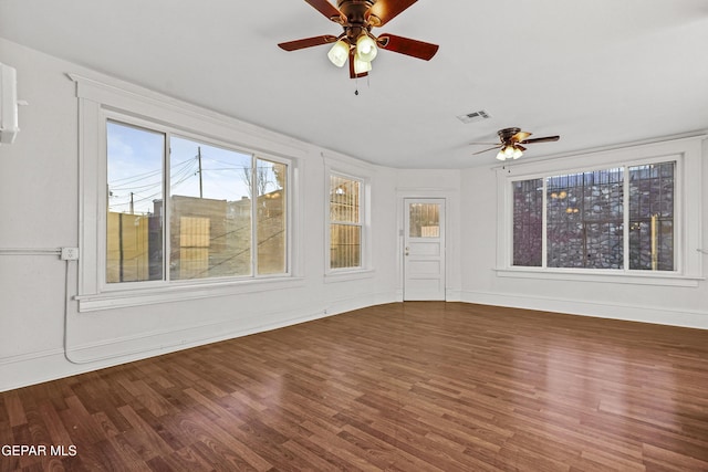 unfurnished sunroom featuring ceiling fan