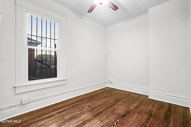 spare room with hardwood / wood-style floors and ceiling fan