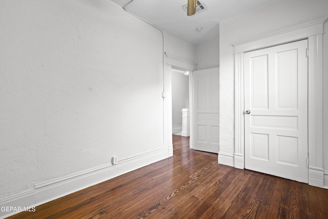 unfurnished bedroom featuring dark hardwood / wood-style flooring