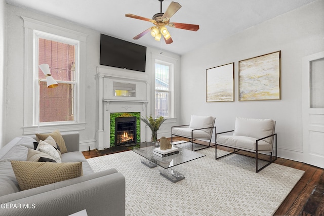 living room featuring ceiling fan and dark hardwood / wood-style flooring