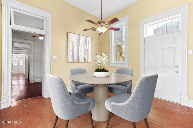 dining space featuring wood-type flooring and ceiling fan