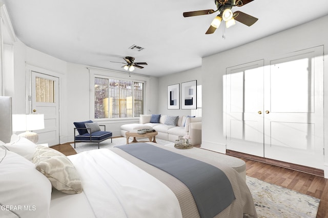 bedroom with ceiling fan and wood-type flooring