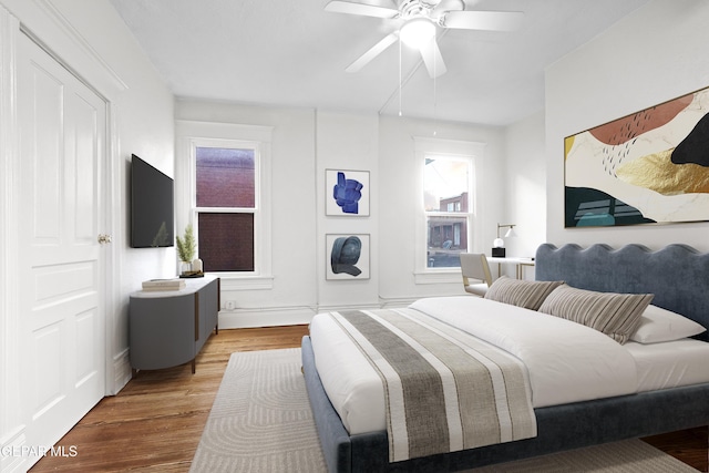 bedroom featuring wood-type flooring and ceiling fan