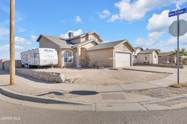 view of front of property with cooling unit and a garage