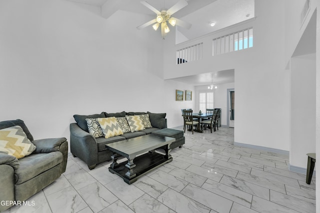 living room featuring ceiling fan with notable chandelier