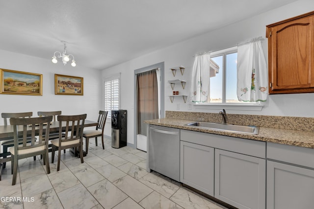 kitchen with sink, decorative light fixtures, stainless steel dishwasher, and a chandelier