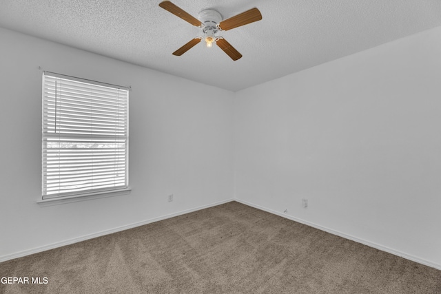 spare room with ceiling fan, carpet floors, and a textured ceiling