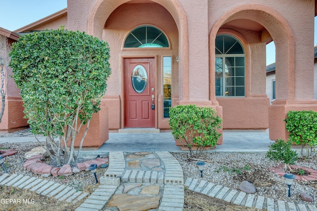 view of exterior entry with stucco siding