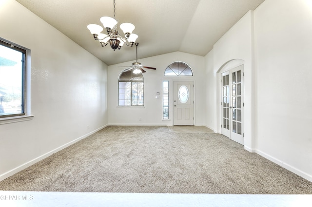 entrance foyer with light carpet, ceiling fan with notable chandelier, baseboards, and lofted ceiling