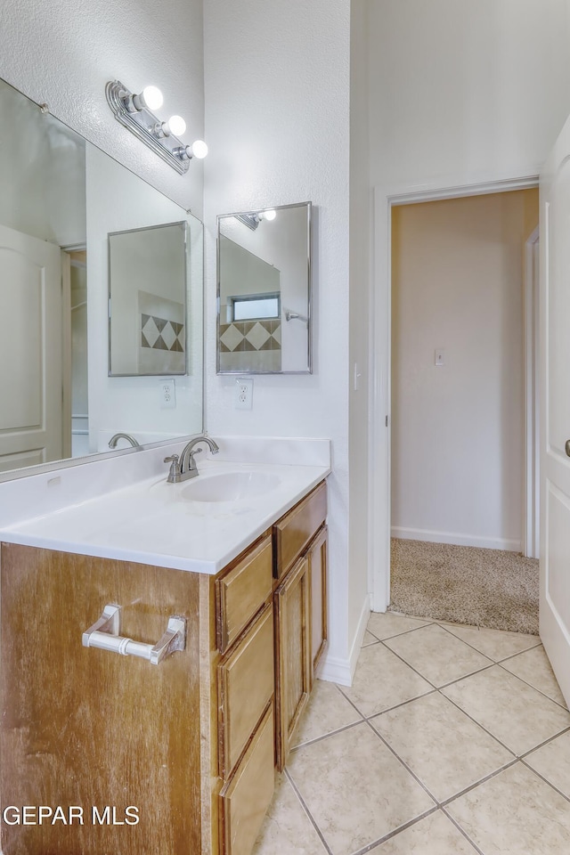 bathroom featuring baseboards, vanity, and tile patterned floors