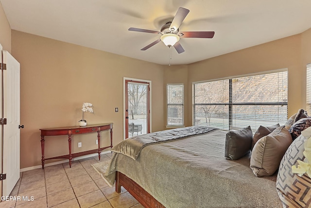 tiled bedroom with access to outside and ceiling fan