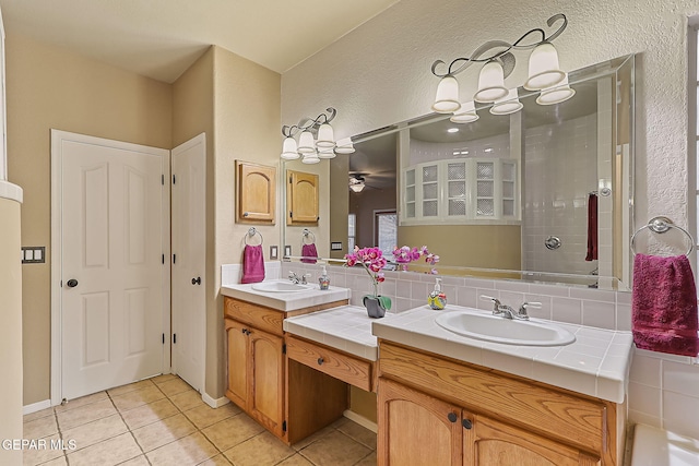 bathroom with tasteful backsplash, tile patterned floors, vanity, and ceiling fan