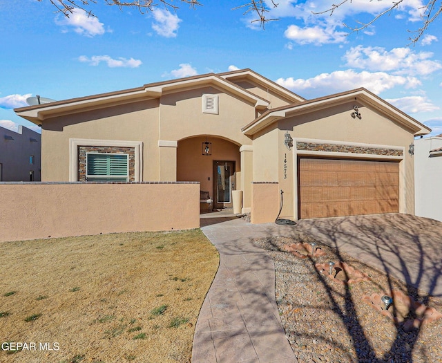 view of front of property featuring a garage and a front lawn