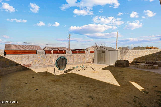 view of yard featuring a storage shed and a playground