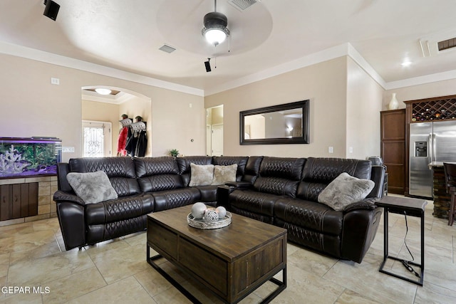 living room with crown molding and ceiling fan