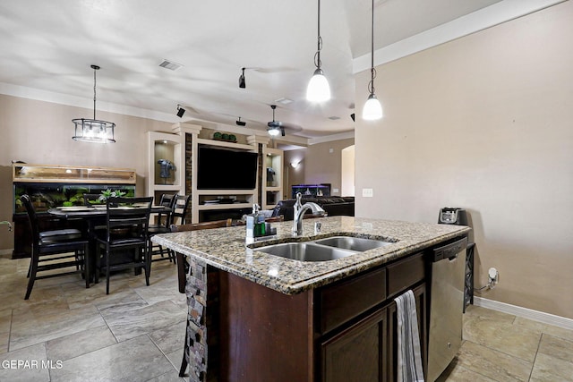 kitchen with pendant lighting, sink, dishwasher, a kitchen island with sink, and light stone counters