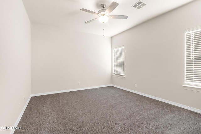 carpeted empty room with plenty of natural light and ceiling fan