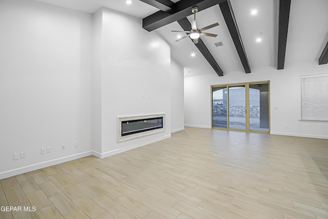 unfurnished living room with beamed ceiling, high vaulted ceiling, ceiling fan, and light hardwood / wood-style floors