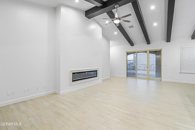 unfurnished living room with ceiling fan, beam ceiling, high vaulted ceiling, and light wood-type flooring