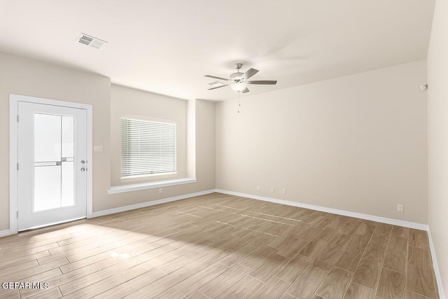 empty room with ceiling fan and light hardwood / wood-style floors