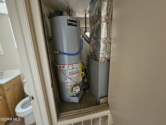 utility room featuring water heater