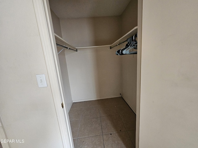 walk in closet featuring tile patterned flooring