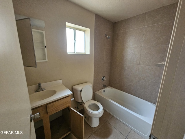 full bathroom featuring vanity, tiled shower / bath, tile patterned floors, and toilet